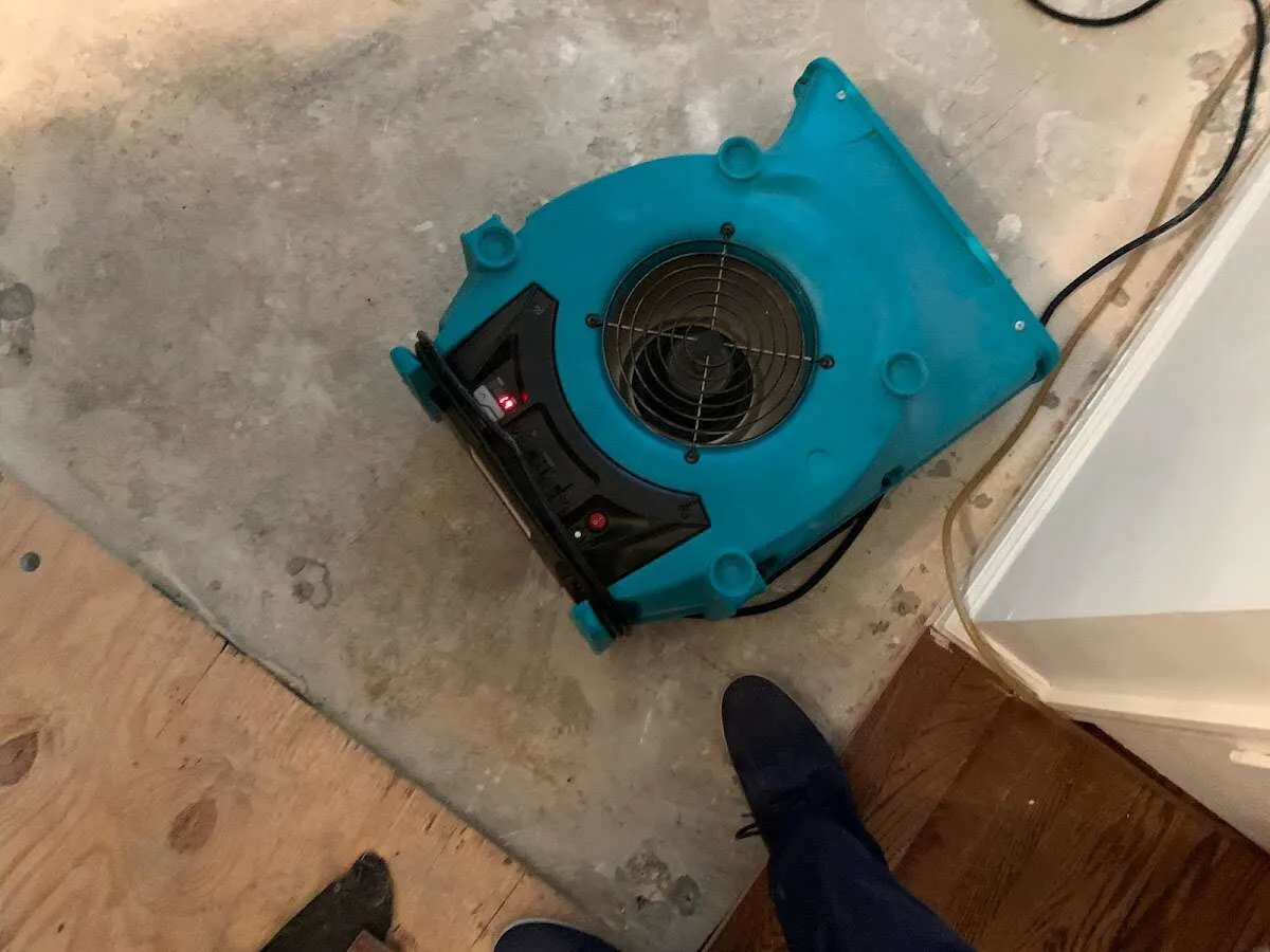 Air mover drying subfloor during Leak Detection & Repair in Tichigan